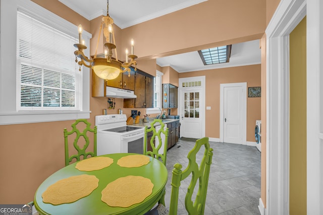 dining room with sink, crown molding, an inviting chandelier, and washer / dryer