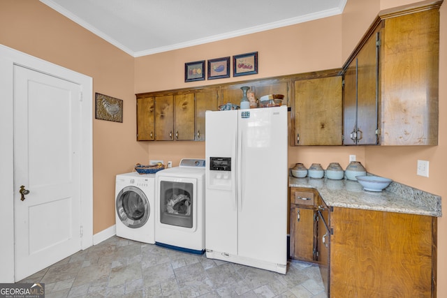 laundry room with ornamental molding, washer and clothes dryer, and cabinets