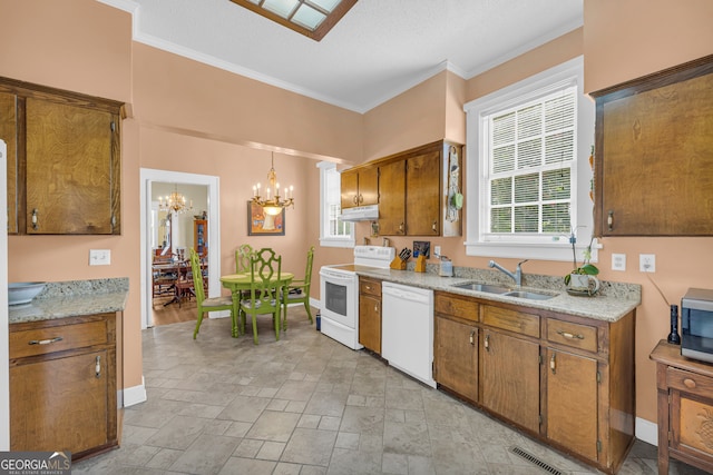 kitchen with decorative light fixtures, sink, ornamental molding, white appliances, and a chandelier