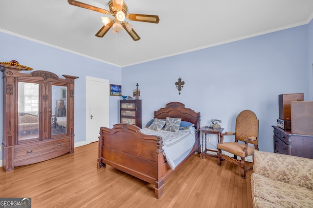 bedroom featuring ceiling fan, light wood-type flooring, crown molding, and lofted ceiling