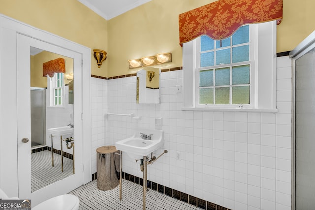 bathroom featuring ornamental molding, tile walls, tile patterned flooring, and toilet