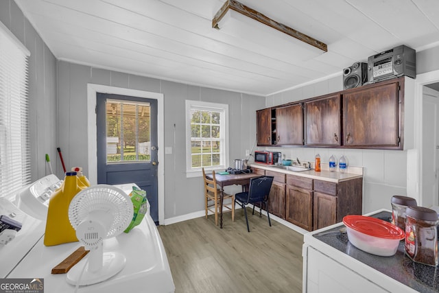 kitchen with light hardwood / wood-style floors, dark brown cabinets, sink, and white electric range