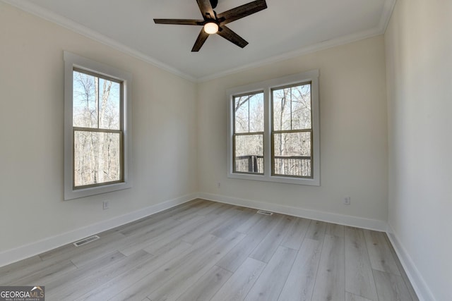 empty room featuring ornamental molding, ceiling fan, and light hardwood / wood-style floors