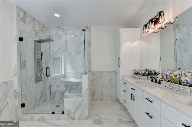 bathroom featuring vanity, tile walls, and walk in shower