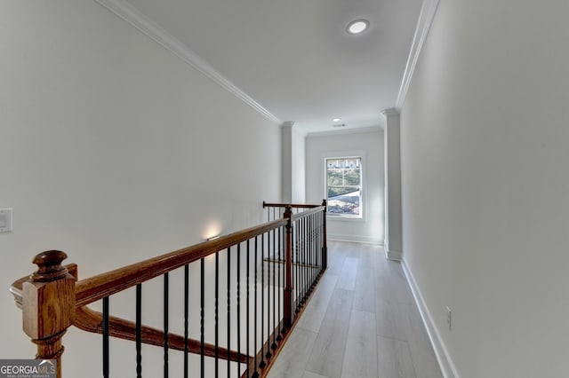 hall featuring ornamental molding and light hardwood / wood-style floors