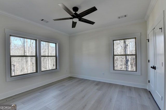 empty room with crown molding, light hardwood / wood-style flooring, and ceiling fan