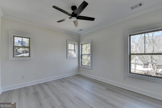 spare room with crown molding, ceiling fan, and light wood-type flooring