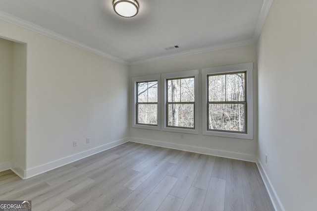 unfurnished room with crown molding and light wood-type flooring