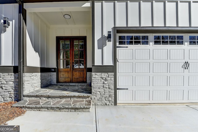 property entrance featuring a garage and french doors