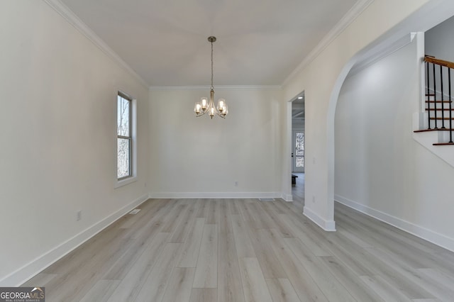 unfurnished dining area with an inviting chandelier, crown molding, and light wood-type flooring