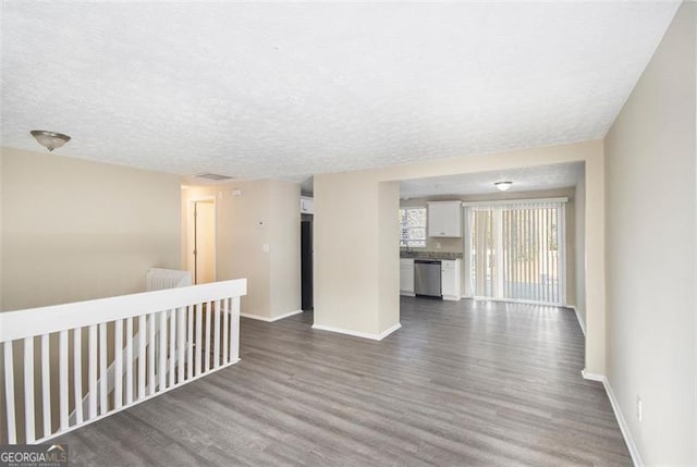 empty room featuring a textured ceiling and hardwood / wood-style flooring