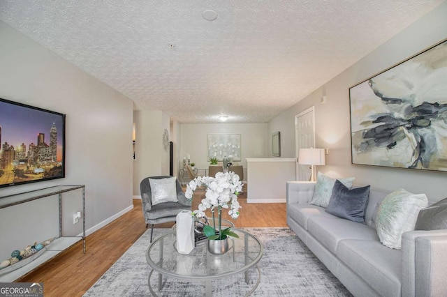 living room featuring light hardwood / wood-style floors and a textured ceiling