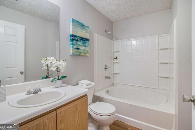 full bathroom with a textured ceiling, shower / tub combination, hardwood / wood-style floors, vanity, and toilet