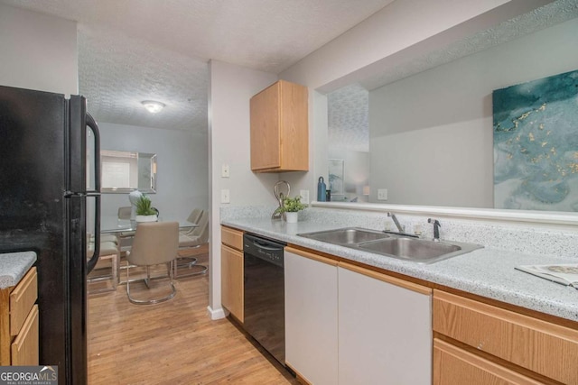 kitchen with a textured ceiling, black appliances, white cabinetry, light hardwood / wood-style floors, and sink