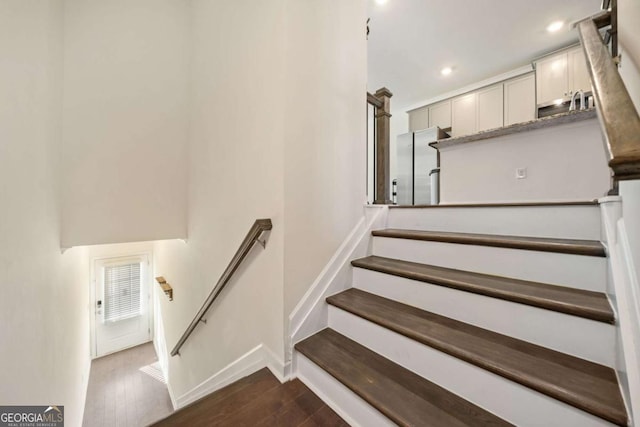 stairway with hardwood / wood-style flooring