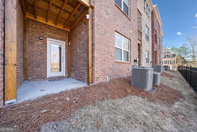 entrance to property with central AC unit and a patio