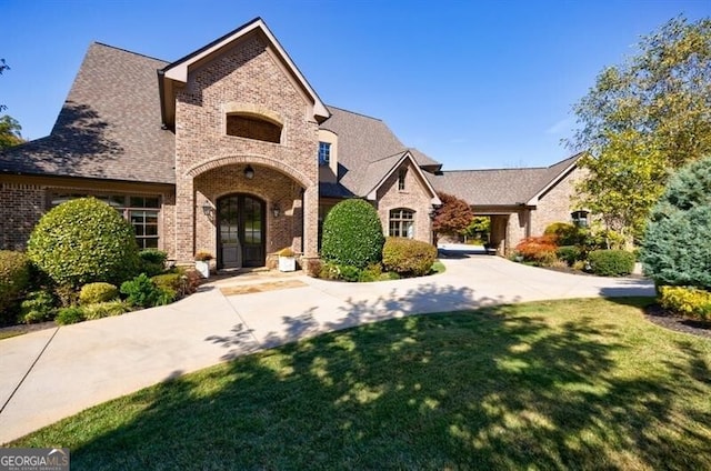 french country style house featuring a front yard