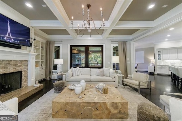 living room with beamed ceiling, a fireplace, built in features, ornamental molding, and coffered ceiling