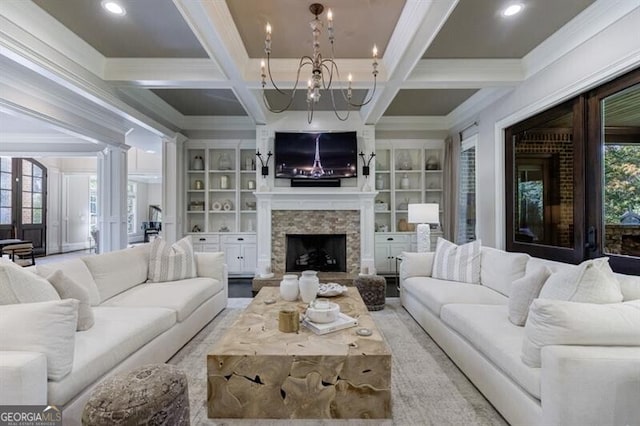 living room featuring plenty of natural light, built in shelves, beam ceiling, and coffered ceiling