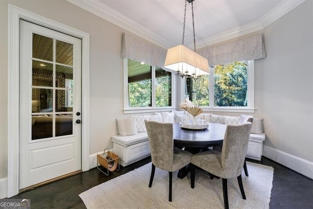 dining space with an inviting chandelier and ornamental molding