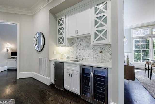 bar featuring white cabinetry, decorative backsplash, dark wood-type flooring, wine cooler, and sink