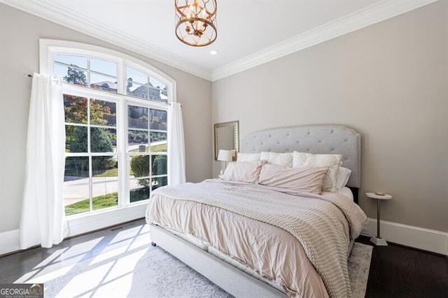 bedroom featuring a chandelier, crown molding, and hardwood / wood-style flooring