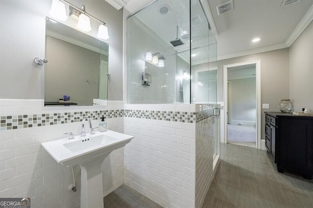 bathroom featuring tile walls, tiled shower, and ornamental molding