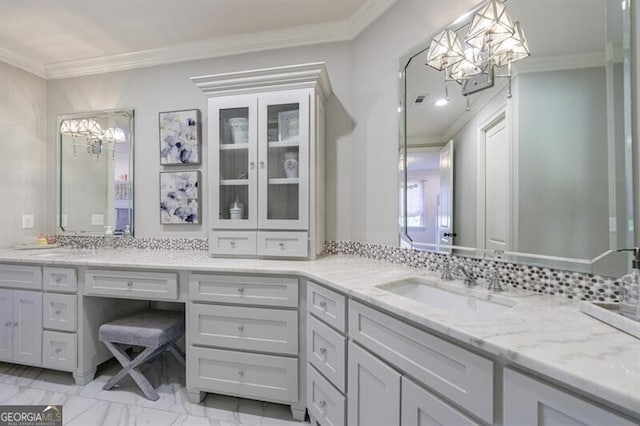 bathroom featuring crown molding, backsplash, vanity, and a notable chandelier