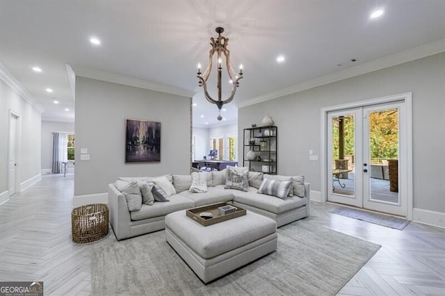 living room featuring light parquet flooring, a chandelier, crown molding, and a healthy amount of sunlight