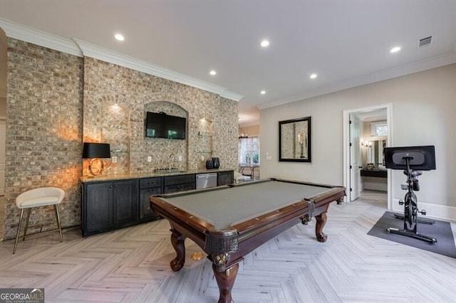 recreation room with crown molding, light parquet floors, and wet bar