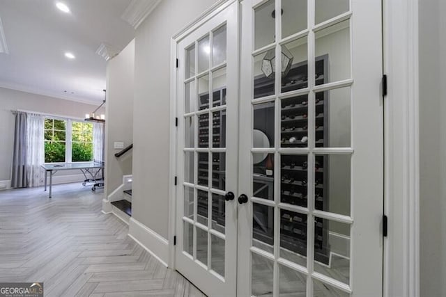 interior details with parquet flooring, french doors, an inviting chandelier, and ornamental molding