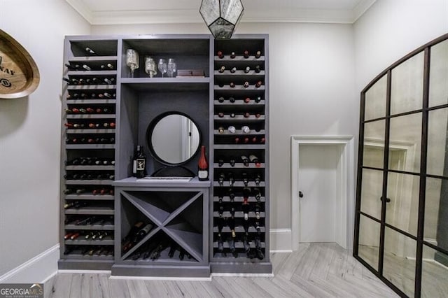 wine area featuring parquet floors and crown molding