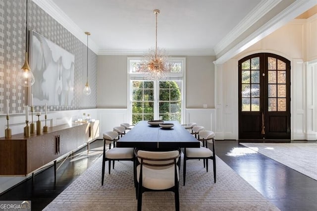 dining room with french doors, a notable chandelier, ornamental molding, and dark hardwood / wood-style floors