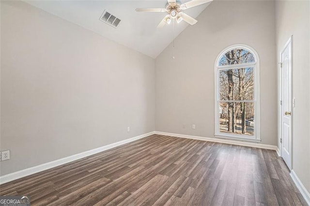 spare room featuring ceiling fan, a wealth of natural light, dark hardwood / wood-style floors, and high vaulted ceiling