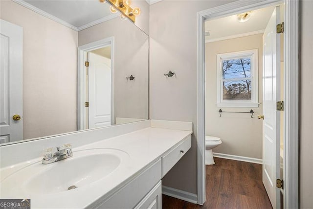 bathroom with wood-type flooring, toilet, vanity, and crown molding