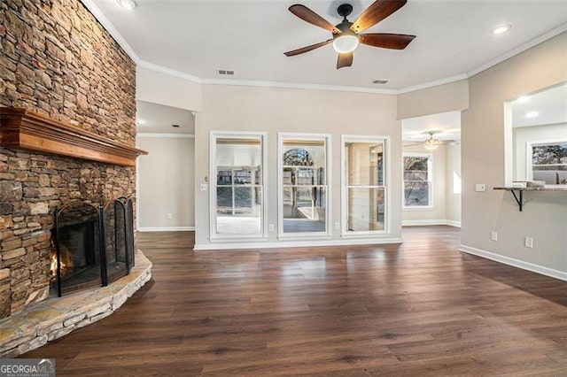 unfurnished living room featuring ceiling fan, dark hardwood / wood-style flooring, crown molding, and a fireplace