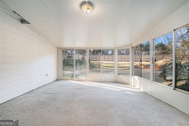 unfurnished sunroom with lofted ceiling