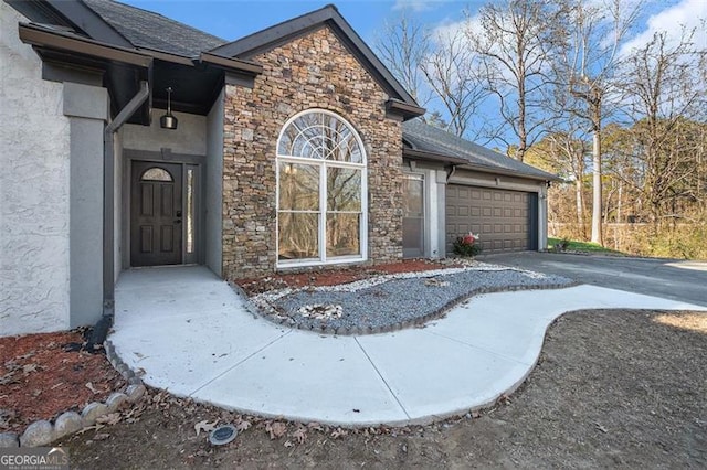 doorway to property with a garage