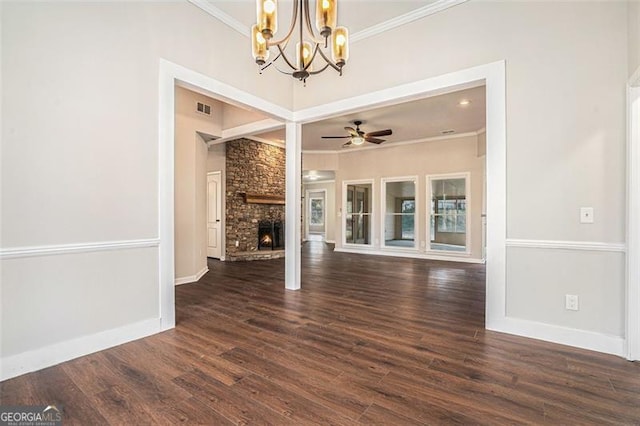 unfurnished living room with a brick fireplace, dark hardwood / wood-style floors, ornamental molding, and ceiling fan with notable chandelier