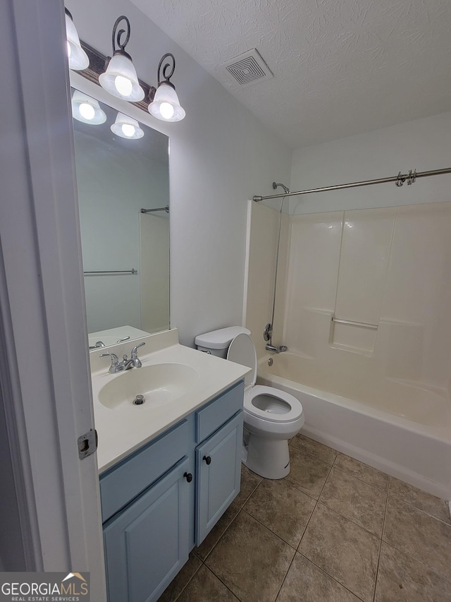 full bathroom with a textured ceiling, shower / tub combination, tile patterned floors, vanity, and toilet