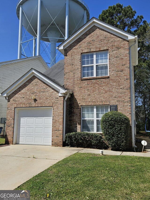 view of front property featuring a front lawn and a garage