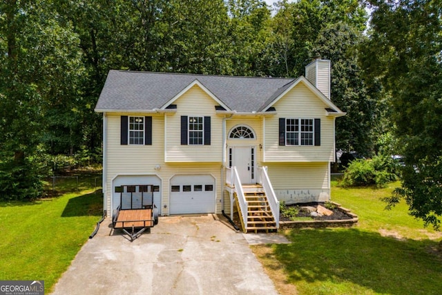 raised ranch with a garage and a front yard