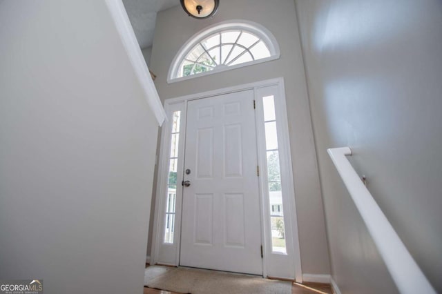 entryway with a towering ceiling and plenty of natural light