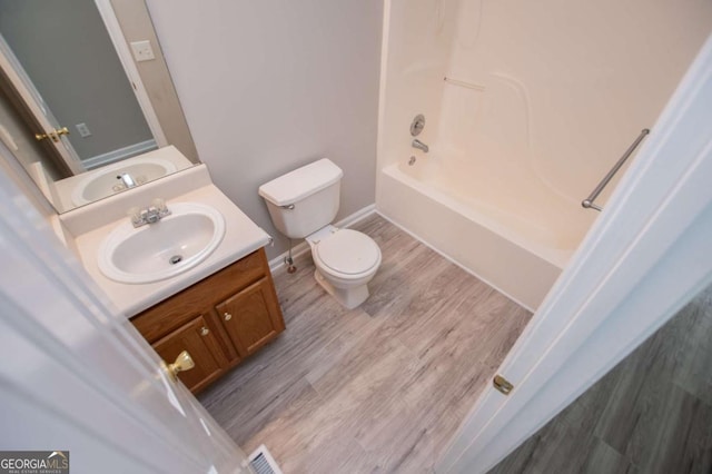 full bathroom with toilet, vanity, shower / tub combination, and hardwood / wood-style floors