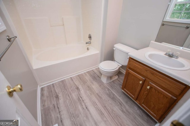 full bathroom featuring shower / tub combination, toilet, hardwood / wood-style flooring, and vanity