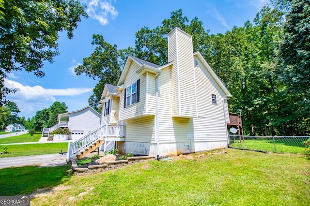 view of property exterior featuring a garage and a yard