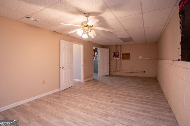 unfurnished room featuring light hardwood / wood-style floors, a paneled ceiling, and ceiling fan