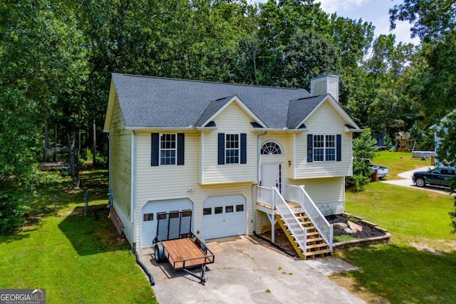 raised ranch featuring a front lawn and a garage