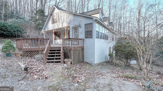 view of home's exterior featuring a wooden deck