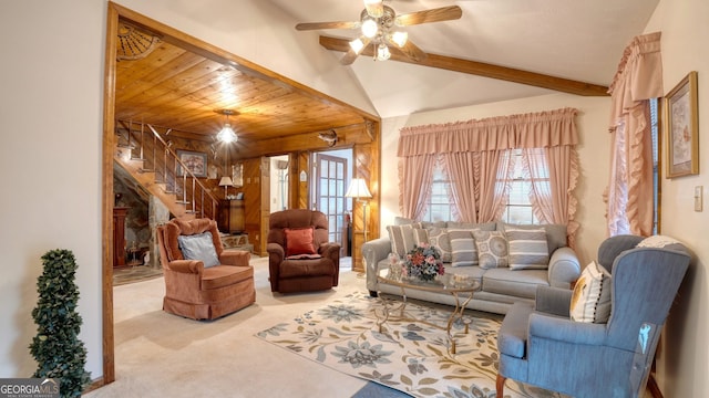 living room featuring ceiling fan, light colored carpet, beam ceiling, and wood ceiling